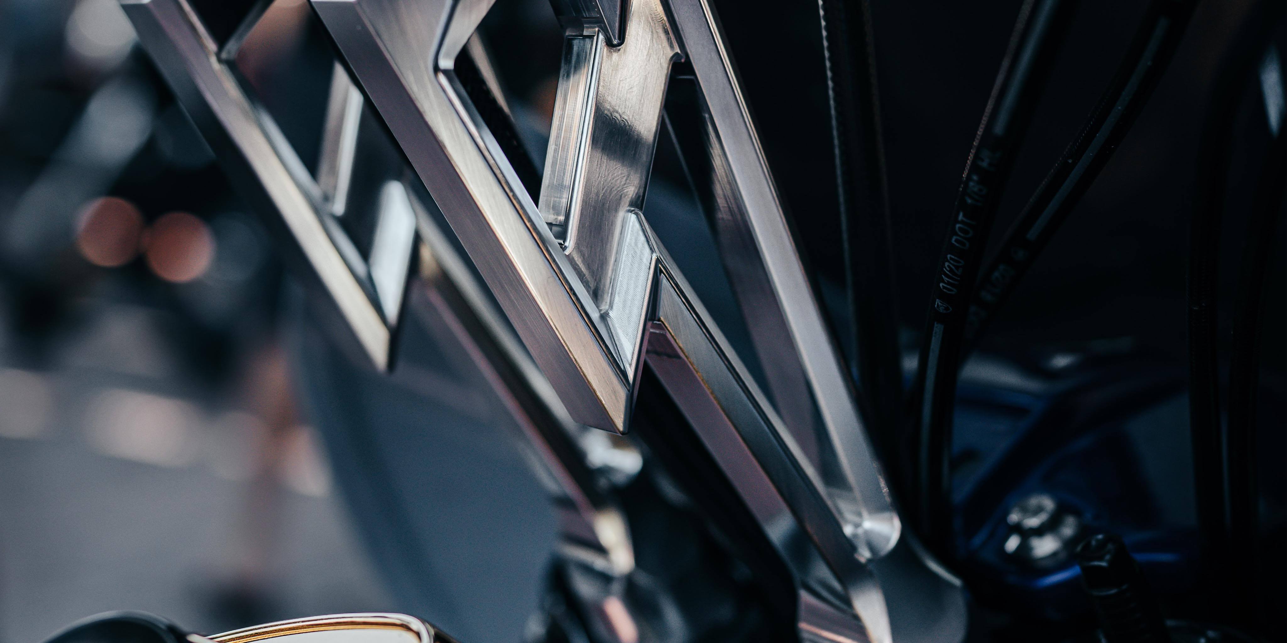 Close up shot of Lucky Speed Shop's 6061 aluminum lightning strike risers mounted on a harley fxr showing a closer look at the fine cnc milling details